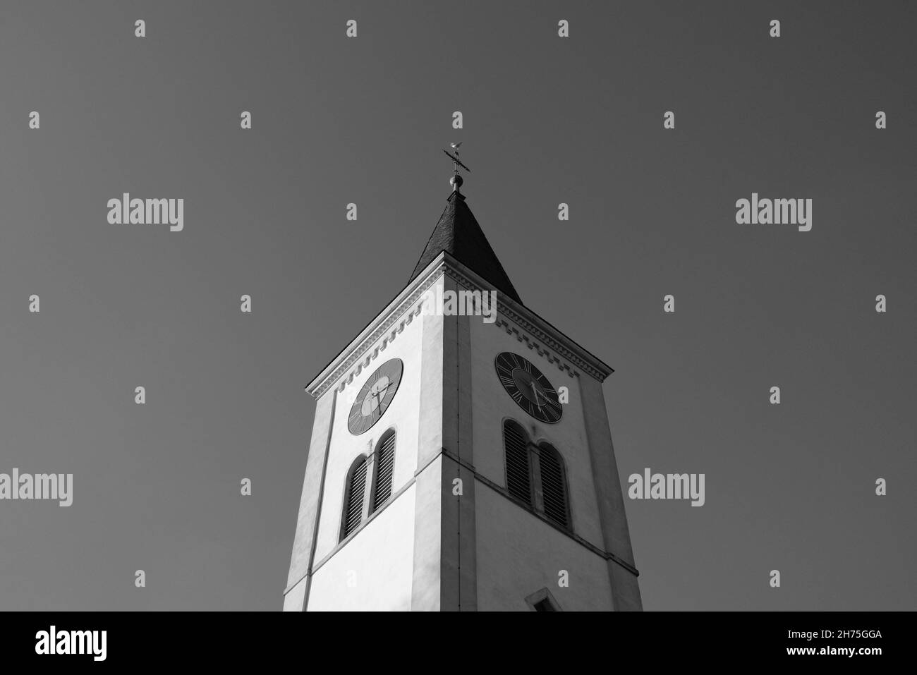 Low angle grayscale shot of a tall church with a steep roof under a ...