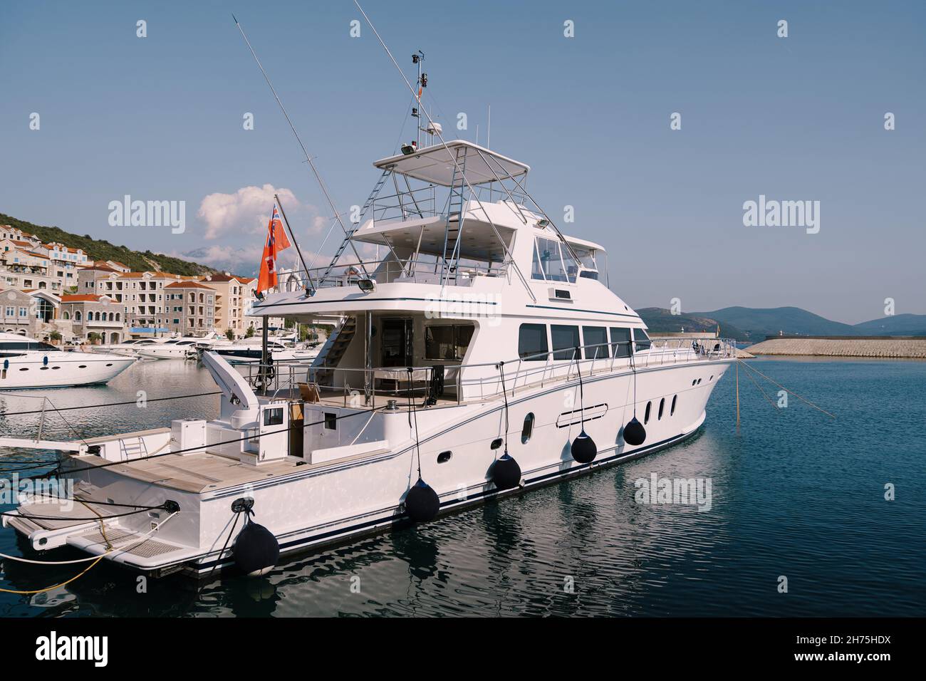 White yacht at the pier. Lustica bay, Montenegro Stock Photo - Alamy