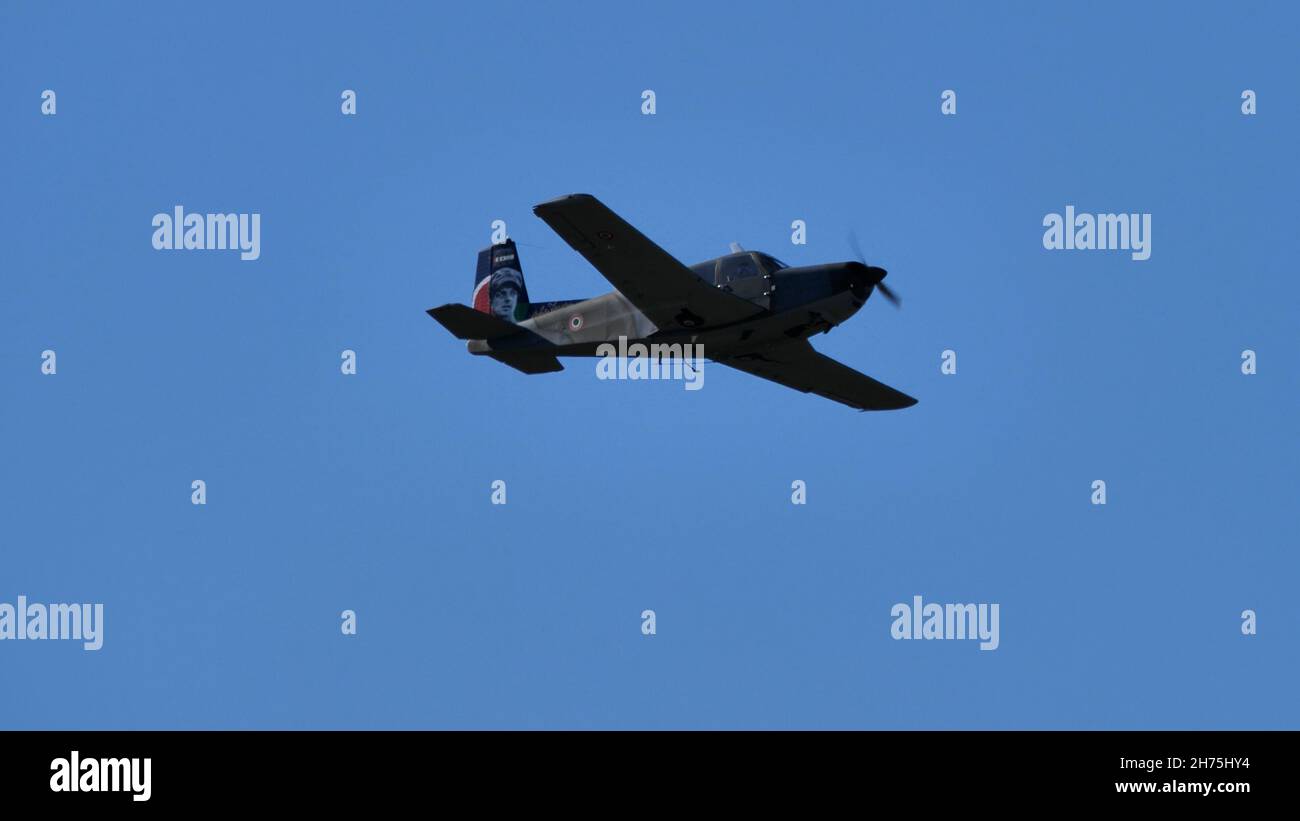 Rivolto del Friuli, Udine, Italy SEPTEMBER, 17, 2021 Military propeller plane with green and brown camouflage flying in the blue sky. SIAI Marchetti S.208 of Italian Air Force Stock Photo