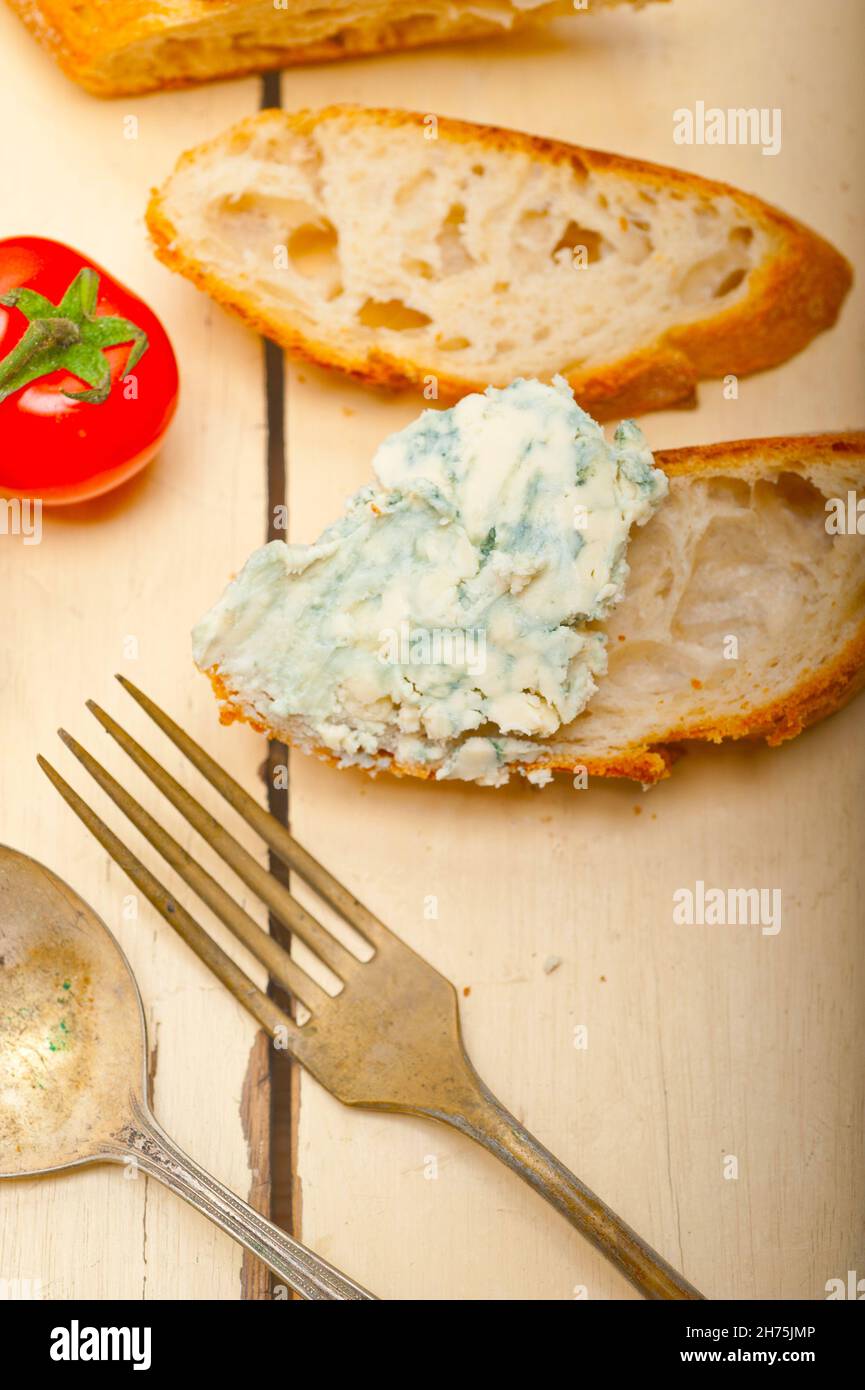 fresh blue cheese spread ove french baguette with cherry tomatoes on