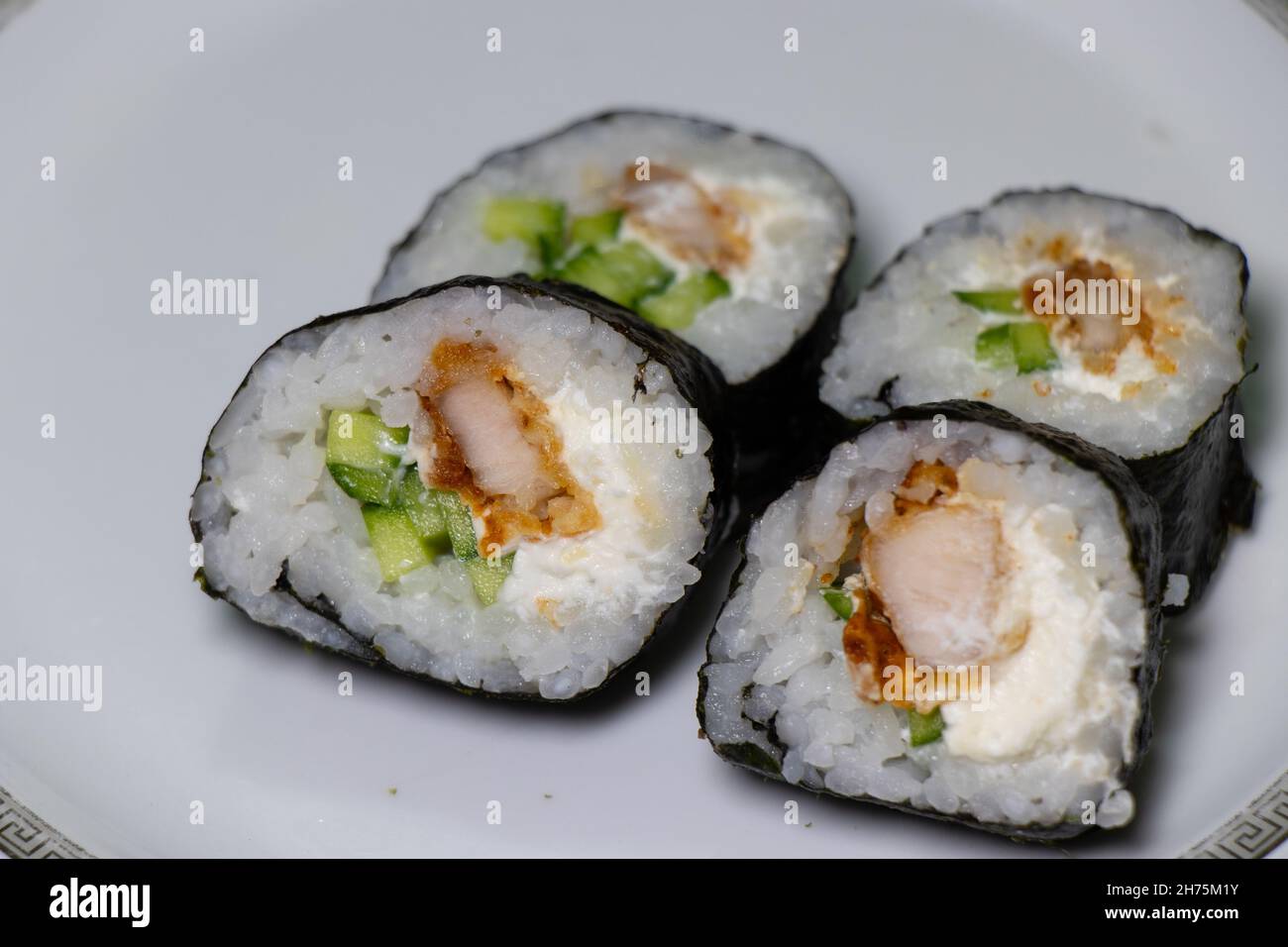 Japanese sushi food on plate. Maki rolls with tuna, chicken, avokado and cucumber Stock Photo