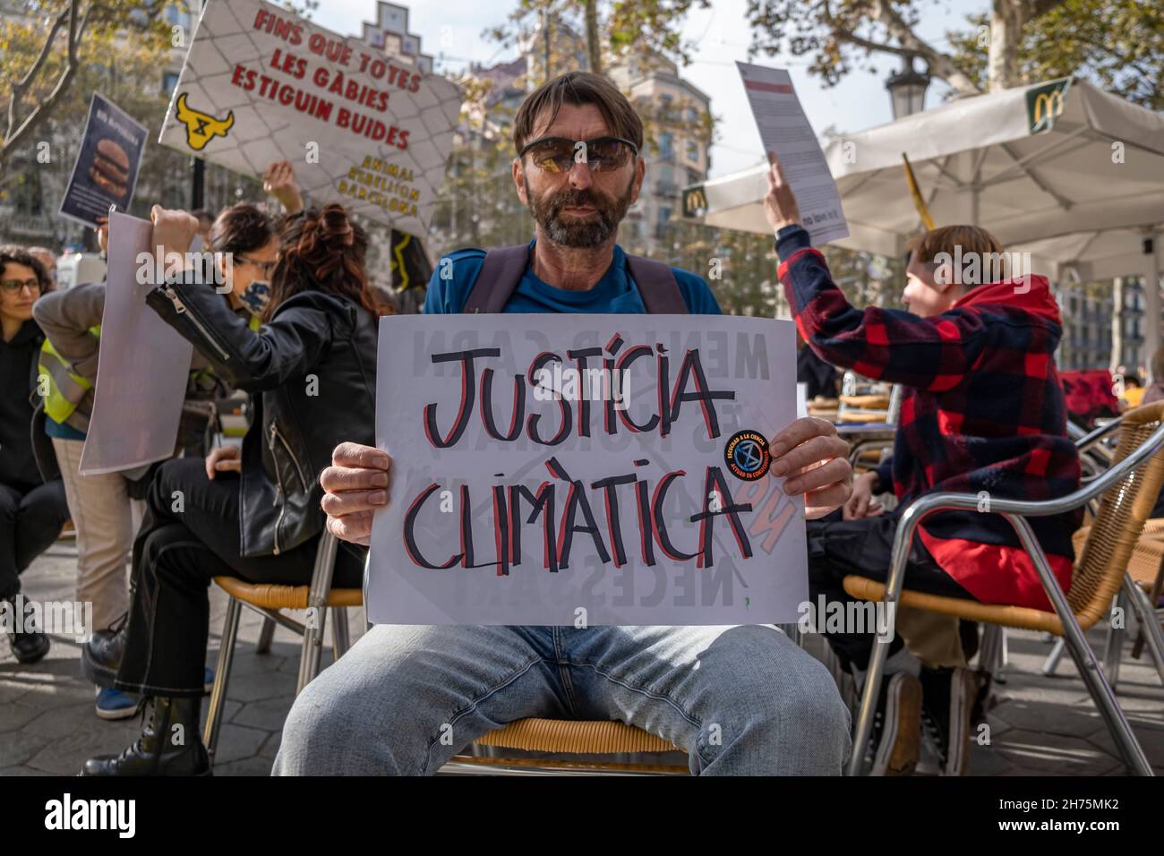 Barcelona, Spain. 20th Nov, 2021. An activist holding a placard expressing his opinion, during the demonstration.Animal Rebellion activists occupied a terrace of a McDonalds establishment in Passeig de Gràcia in Barcelona demanding the transition to a fairer and more sustainable food system. Credit: SOPA Images Limited/Alamy Live News Stock Photo