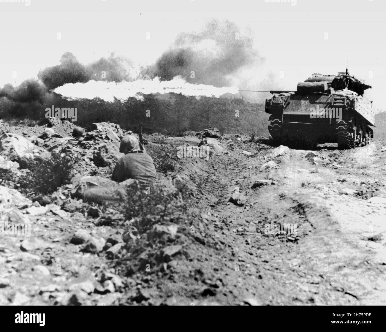 IWO JIMA, PACIFIC OCEAN - March 1945 - A Marine flame throwing tank, also known as a 'Ronson', scorches a Japanese strongpoint. The eight M4A3 Sherman Stock Photo