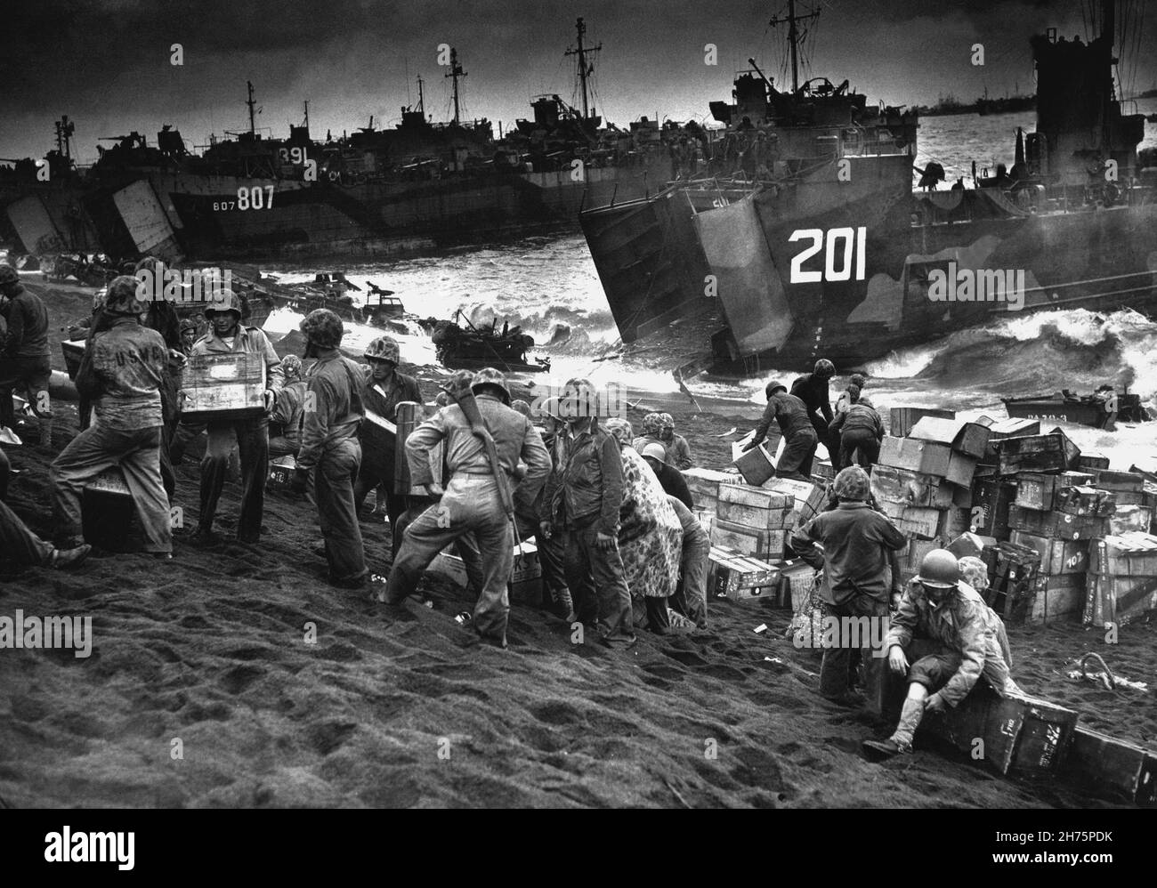 IWO JIMA, PACIFIC OCEAN - 19 February 1945 - Out of the gaping mouths of US Coast Guard and US Navy Landing Craft, rose the great flow of invasion sup Stock Photo