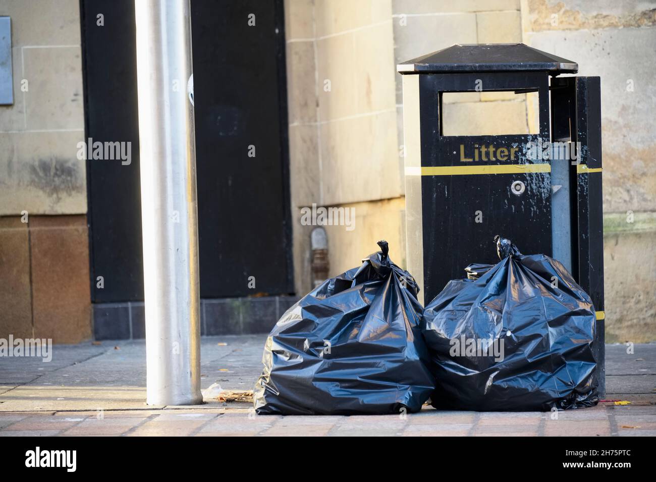Fly tipping of waste and rubbish black bin bags in residential area