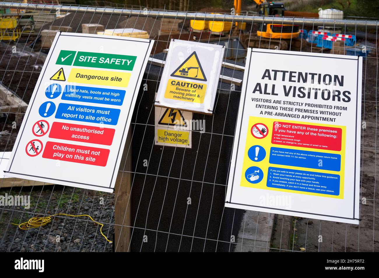 Construction site health and safety message rules sign board signage on fence boundary Stock