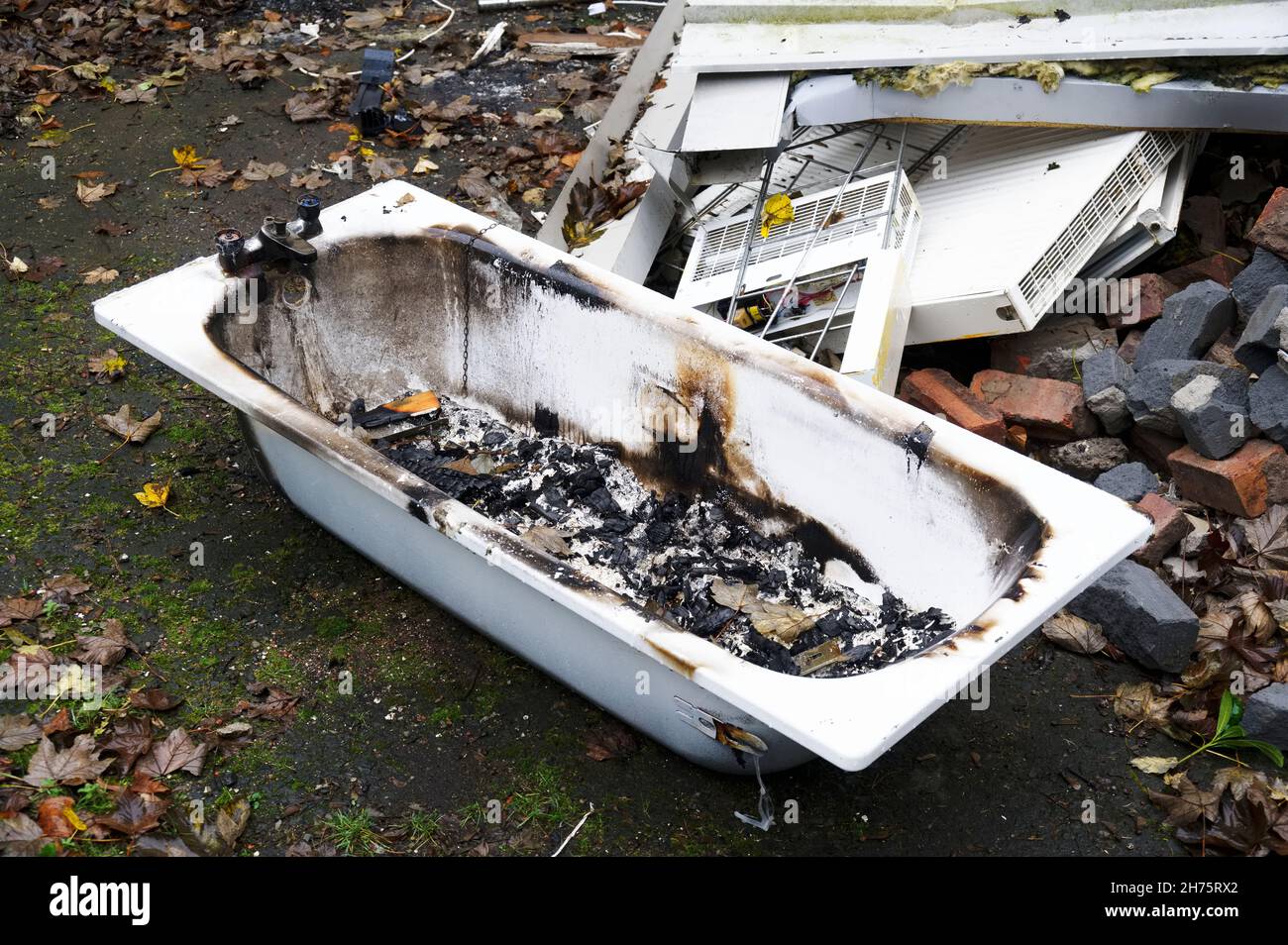 Old ceramic bath from demolition of derelict house on construction building site Stock Photo