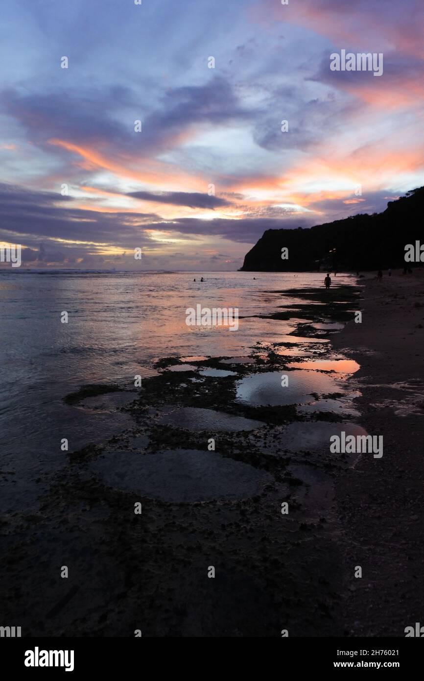 Sunset sky over the sea captured from the sandy beach Stock Photo - Alamy