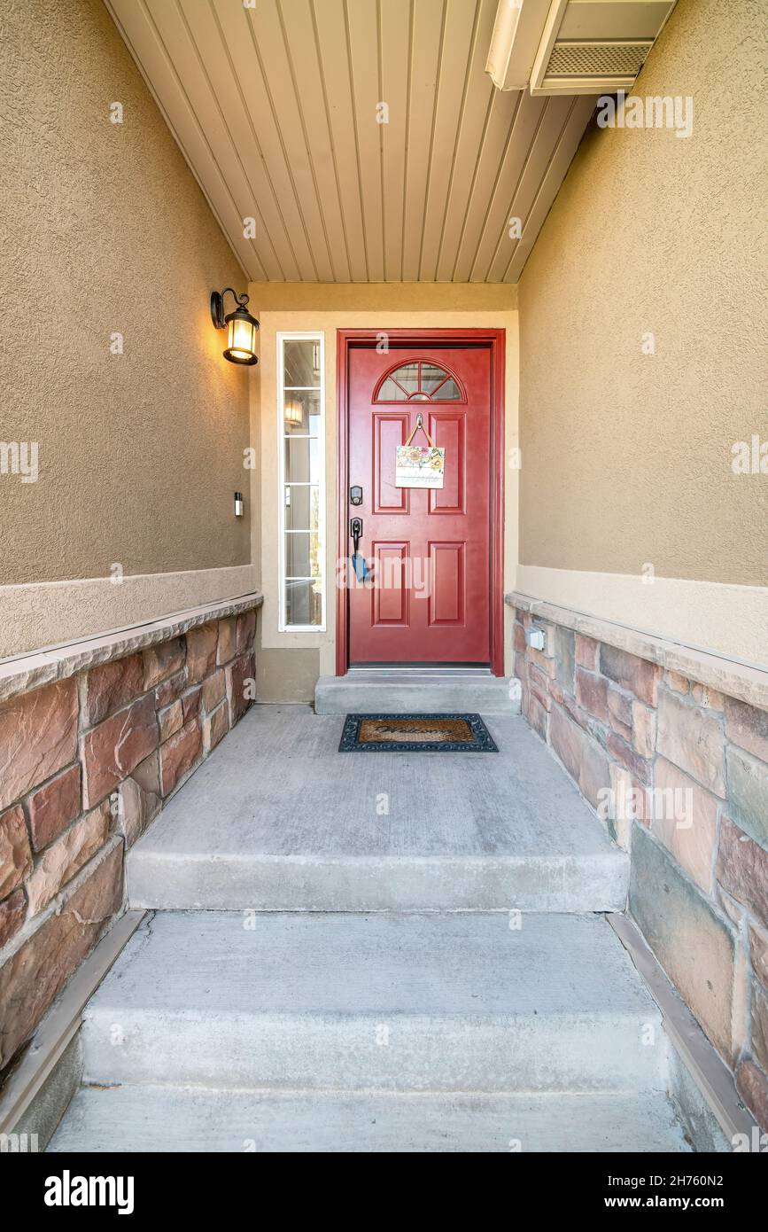 Concrete doorstep of a house with red front door and wall lamp Stock ...