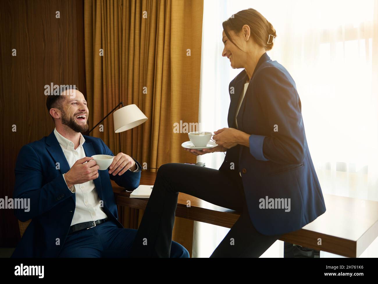 Two business people, partners having a nice conversation over a cup of