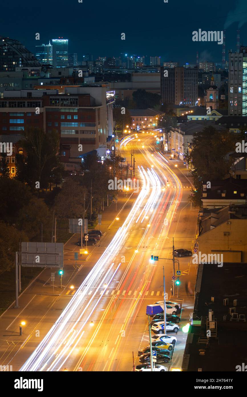 Aerial view of the wide street of the night city which cars move along ...