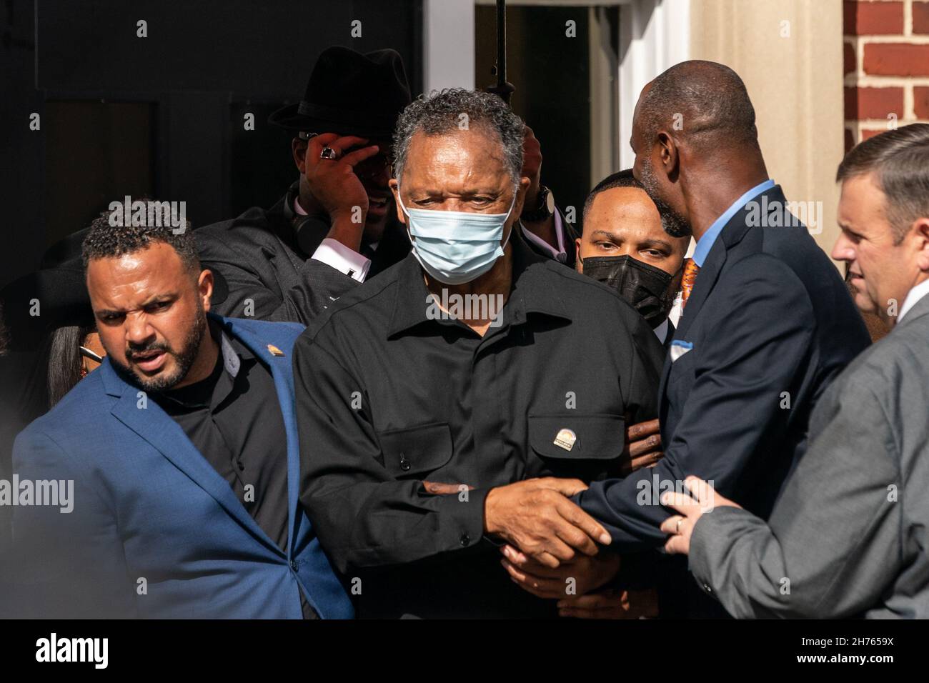 Rev. Jesse Jackson, center, is escorted through the crowd during the Wall of Prayer event in support of justice for Ahmaud Arbery outside the Glynn County Courthouse November 18, 2021 in Brunswick, Georgia. The trial of defendants Greg McMichael, Travis McMichael, and a neighbor, William 'Roddie' Bryan continued inside the courthouse. Stock Photo