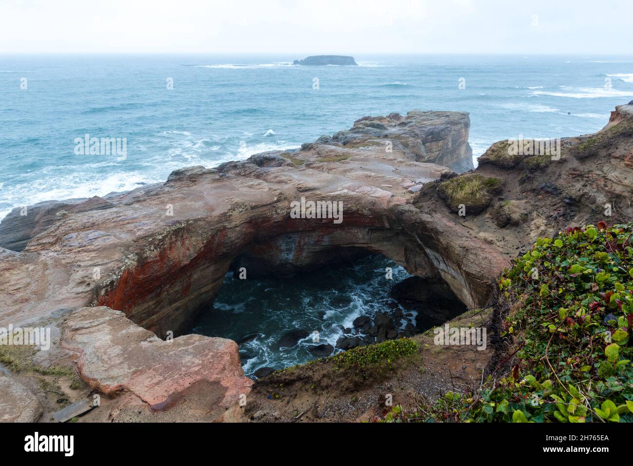 Devils punchbowl an arch with a circular opening Stock Photo