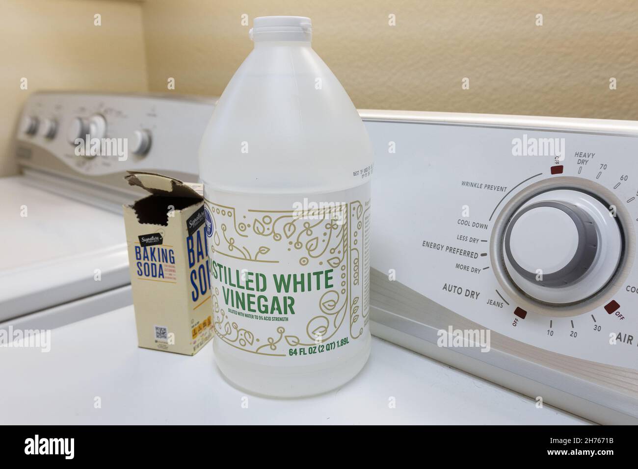White vinegar and baking soda in a laundry room, used for freshening musty towels and other laundry. Stock Photo