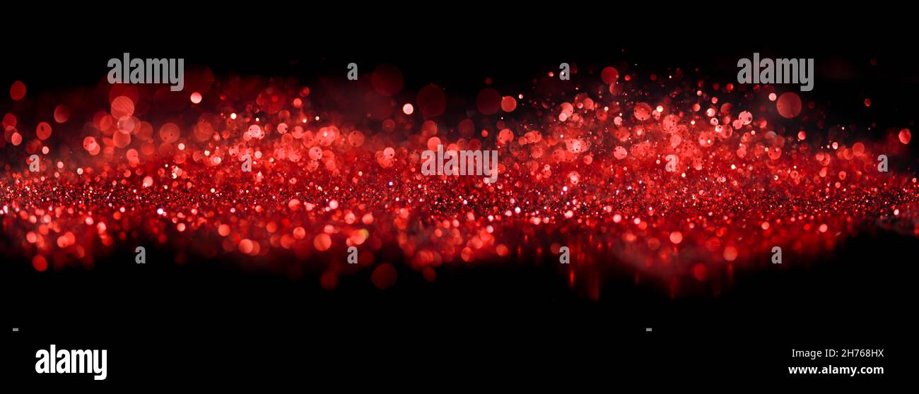 Bokeh of sparkling red lights and glitter on black Stock Photo