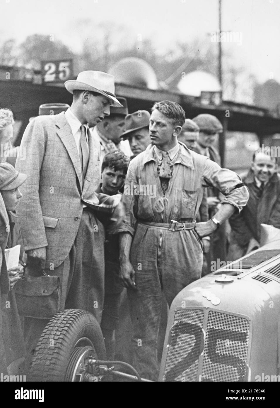 A P R (Tony) Rolt after the Coronation Races 14th May 1938, where he drove car #26, 1500cc  supercharged ERA R5B to two wins.. The gentleman talking to him is Ken Richardson. The car was previously driven by B Bira and R5B is still known today as 'Remus' and one of the most successful racing cars of all time. Stock Photo