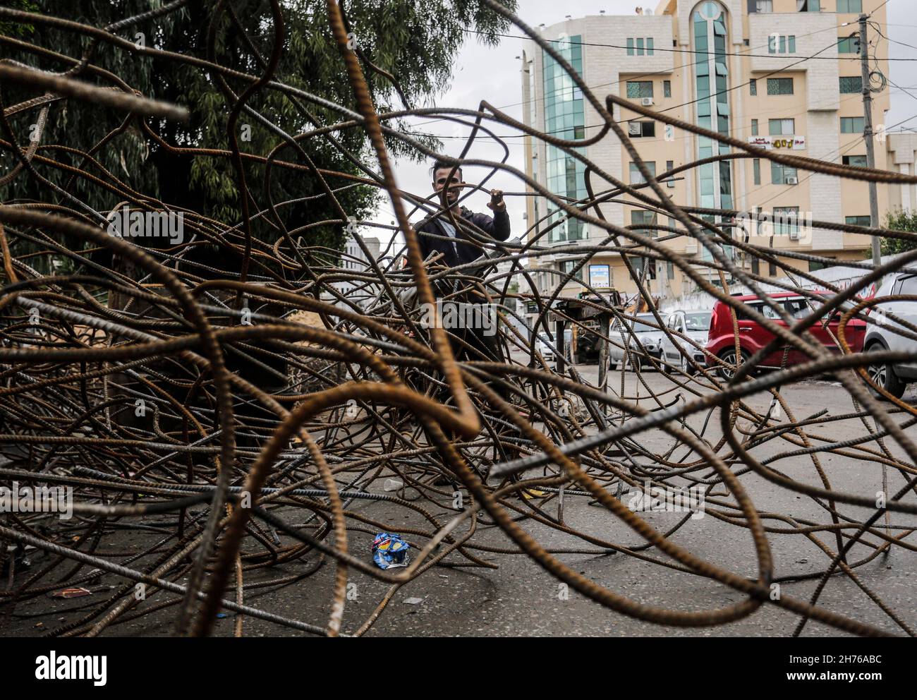 Gaza, Palestine. 20th Nov, 2021. A Palestinian worker collects scrap metal during the clearing of the rubble of Al-Jawhara Tower in Gaza City's Al-Rimal neighbourhood, which was targeted by Israeli airstrikes in May 2021. (Photo by Mahmoud Issa/SOPA Images/Sipa USA) Credit: Sipa USA/Alamy Live News Stock Photo