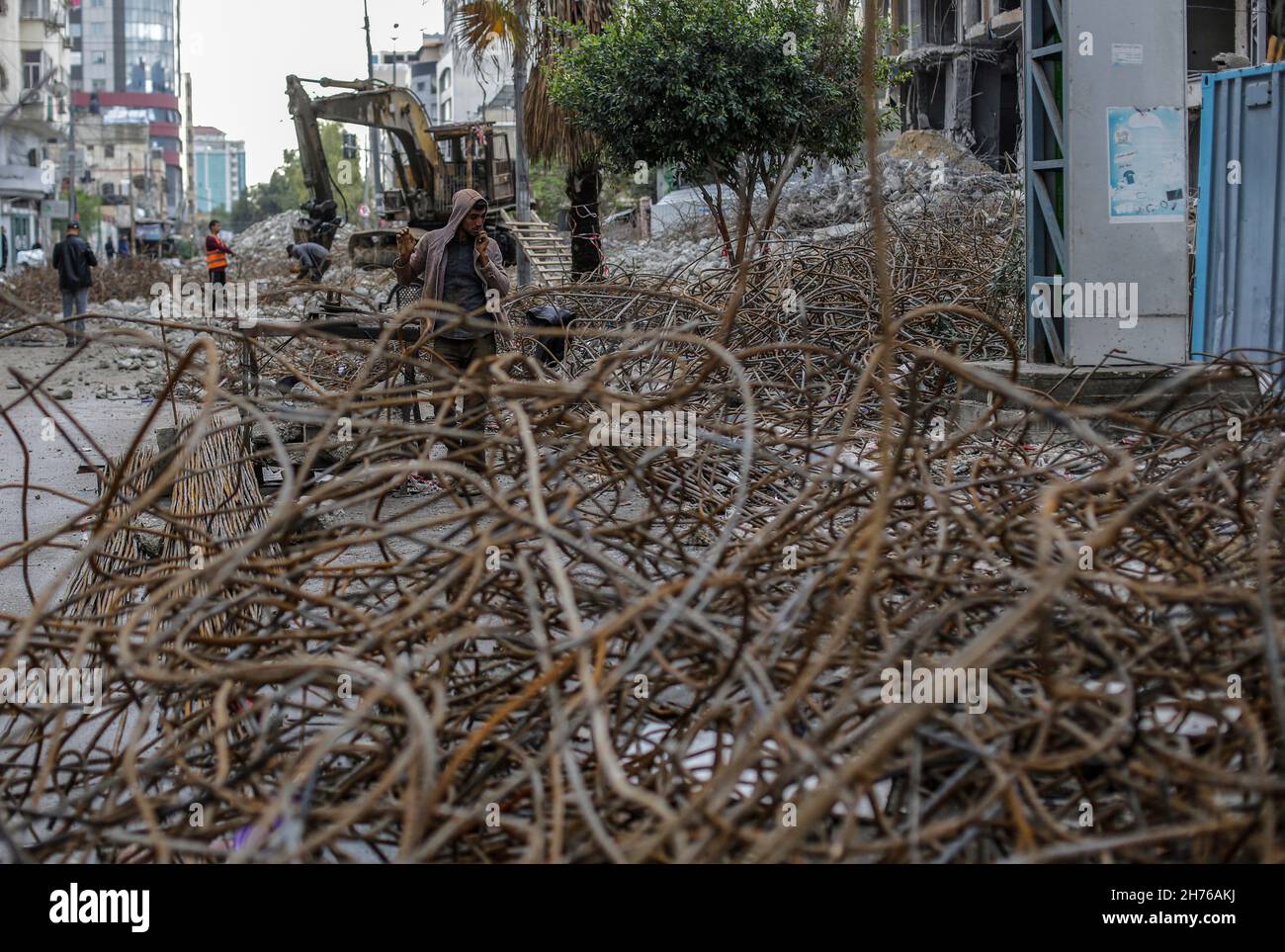 Gaza, Palestine. 20th Nov, 2021. A Palestinian worker collects scrap metal during the clearing of the rubble of Al-Jawhara Tower in Gaza City's Al-Rimal neighbourhood, which was targeted by Israeli airstrikes in May 2021. Credit: SOPA Images Limited/Alamy Live News Stock Photo