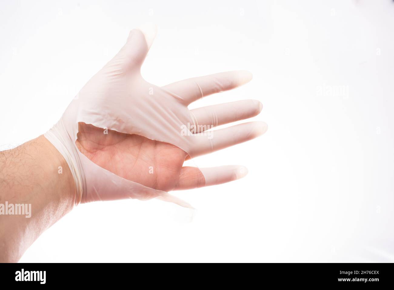 Hands closeup in torn rubber gloves. torn medical gloves after a