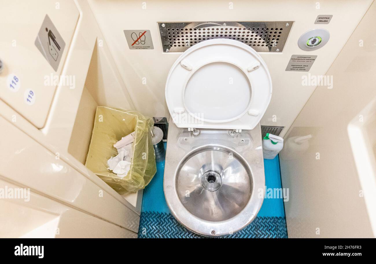 Toilet seat in the bathroom wc of the train Couchette car carriage, economy  class of the Kazakhstan railway modern train Stock Photo - Alamy