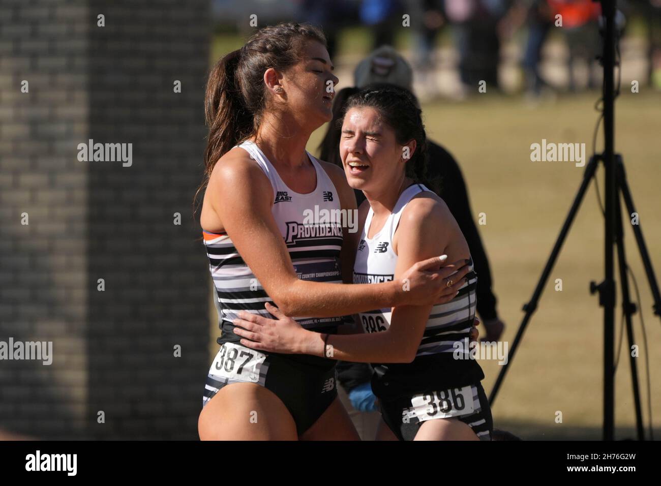 Orla O'Connor (386) and Alex O'Neill (387) of Providence embrace after the women's race during the NCAA cross country championships at Apalachee Regio Stock Photo