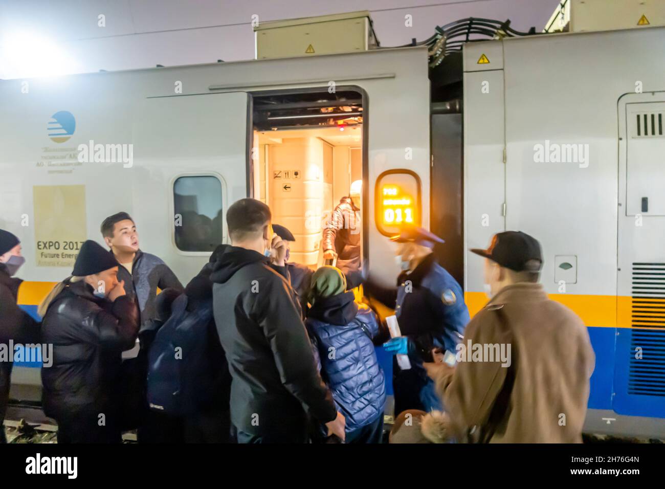 Passengers boarding on the train on the platform of Karagandy Railway stop. Kazakhstan, Central Asia Stock Photo