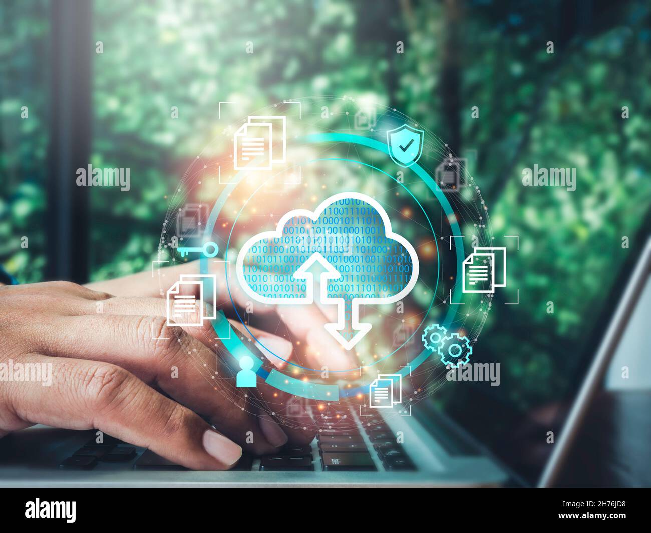 Cloud computing technology concept. Cloud icon virtual with data, security shield, document information symbols appeared while man using a laptop comp Stock Photo