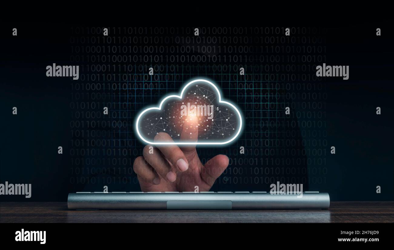 Cloud computing technology concept. Cloud icon virtual appeared while man pointing finger and keyboard computer with network and coding on dark backgr Stock Photo