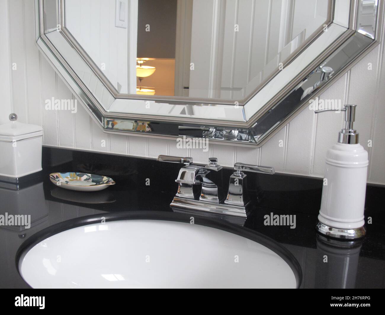 Bathroom vanity with mirror and black granite counter Stock Photo