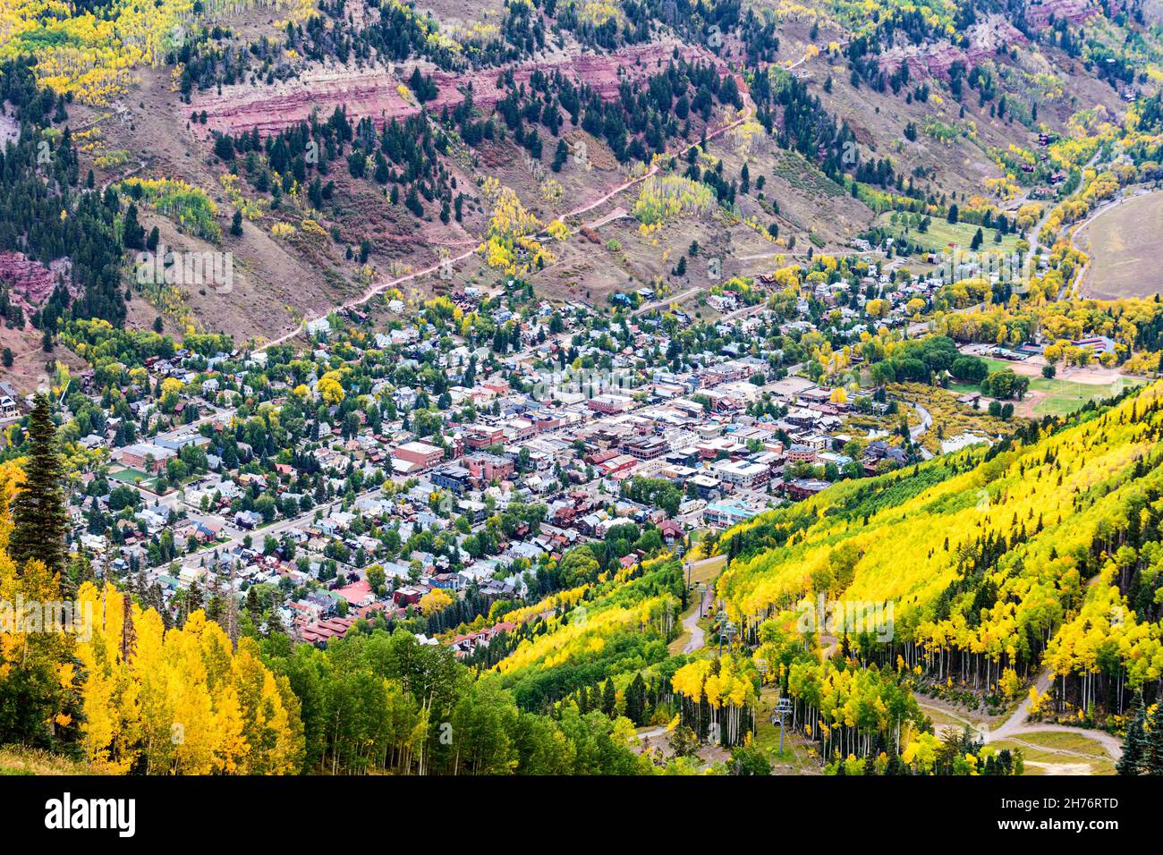 Aerial view of Telluride, Colorado surrounded by autumn foliage forest