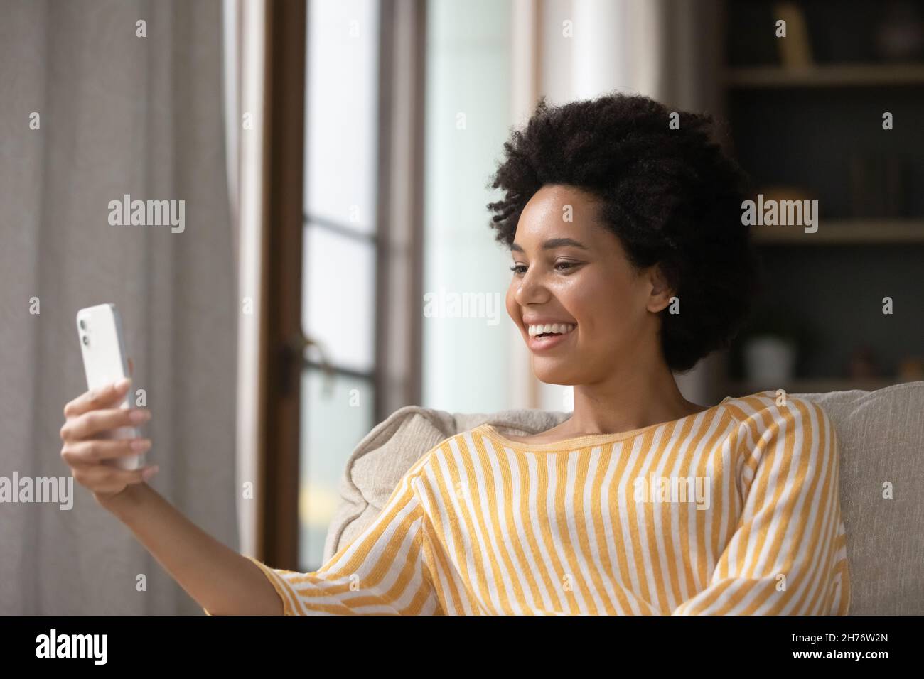 Happy young African American woman speaking on video call Stock Photo ...