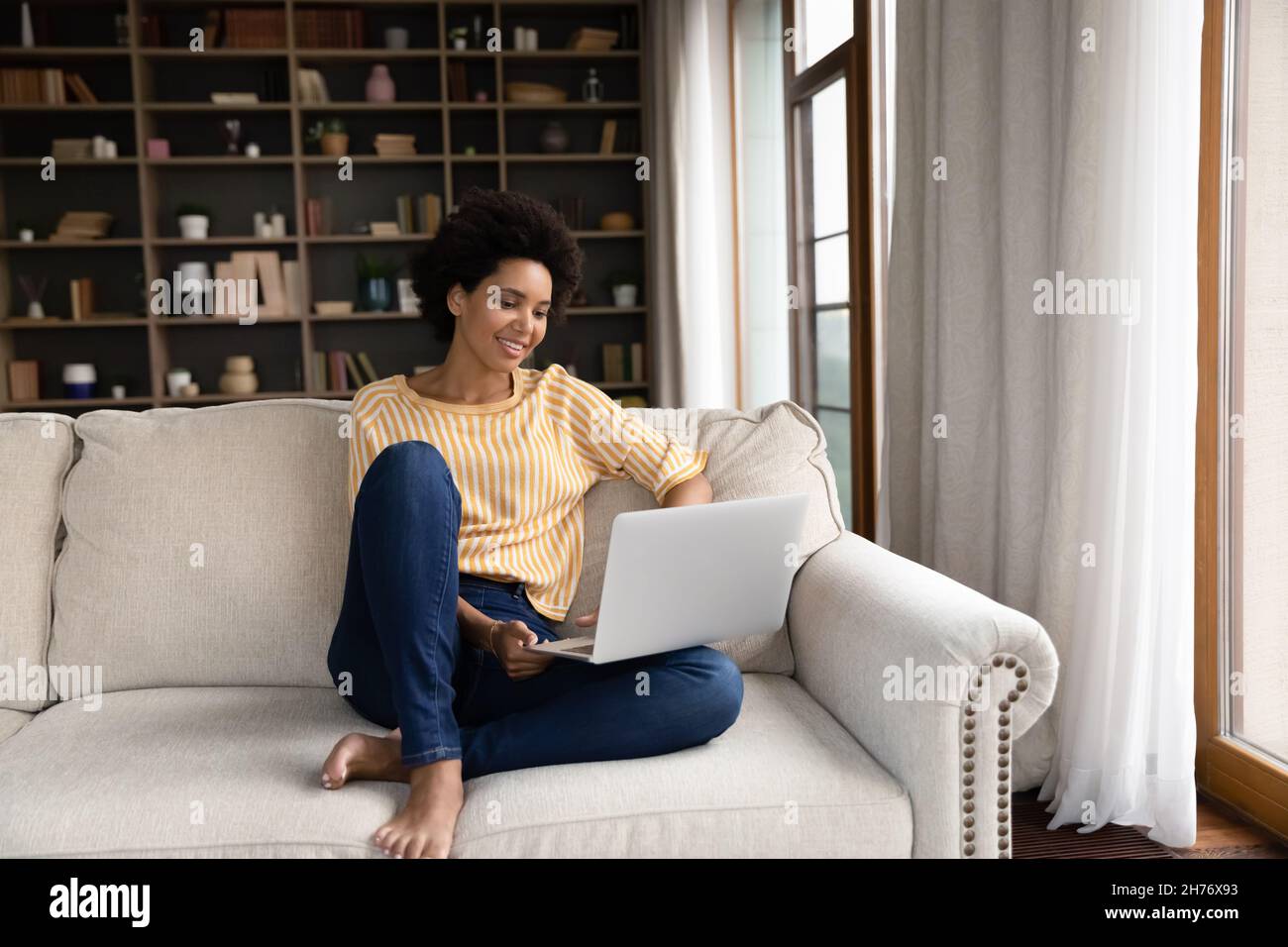 Smiling young Black woman using laptop computer Stock Photo - Alamy