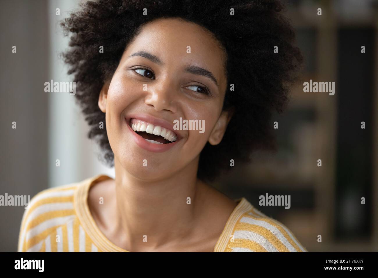 Happy joyful Black girl looking away with toothy smile Stock Photo