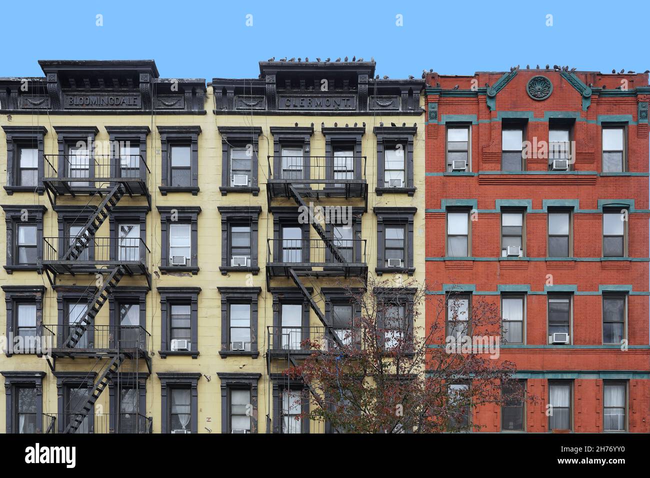 Old fashioned Manhattan apartment building facades with external fire escape ladders Stock Photo
