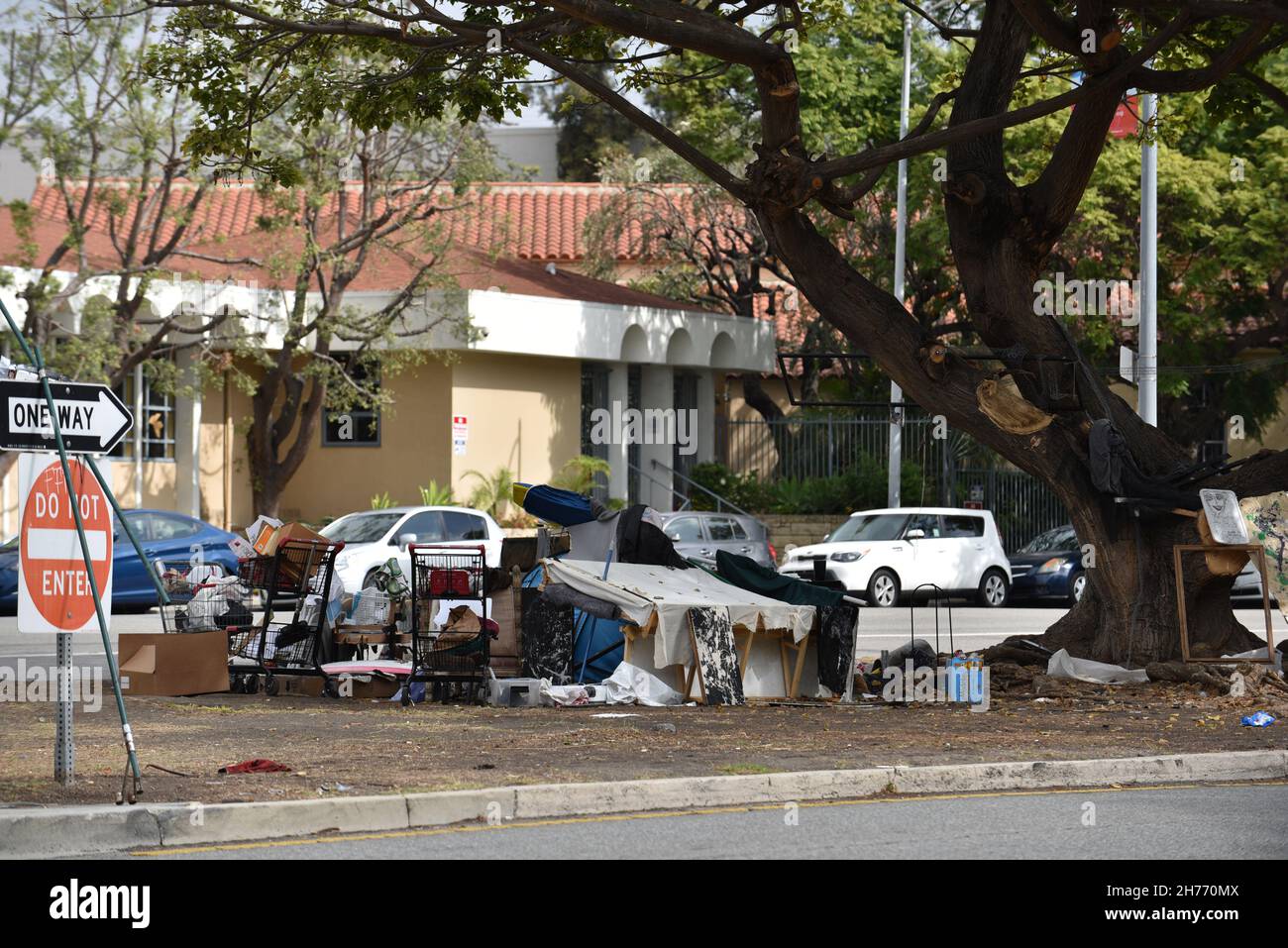 Beverly Hills, CA USA - October 22, 2021: Homeless encampment in Beverly Hills in front of an upscale office building Stock Photo