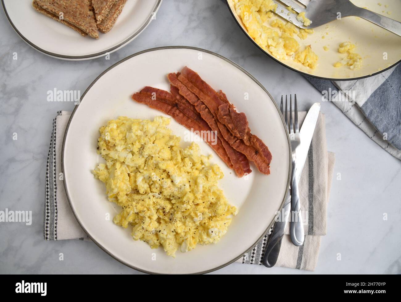 Overhead view of a bacon and egg breakfast with whole grain toast Stock Photo