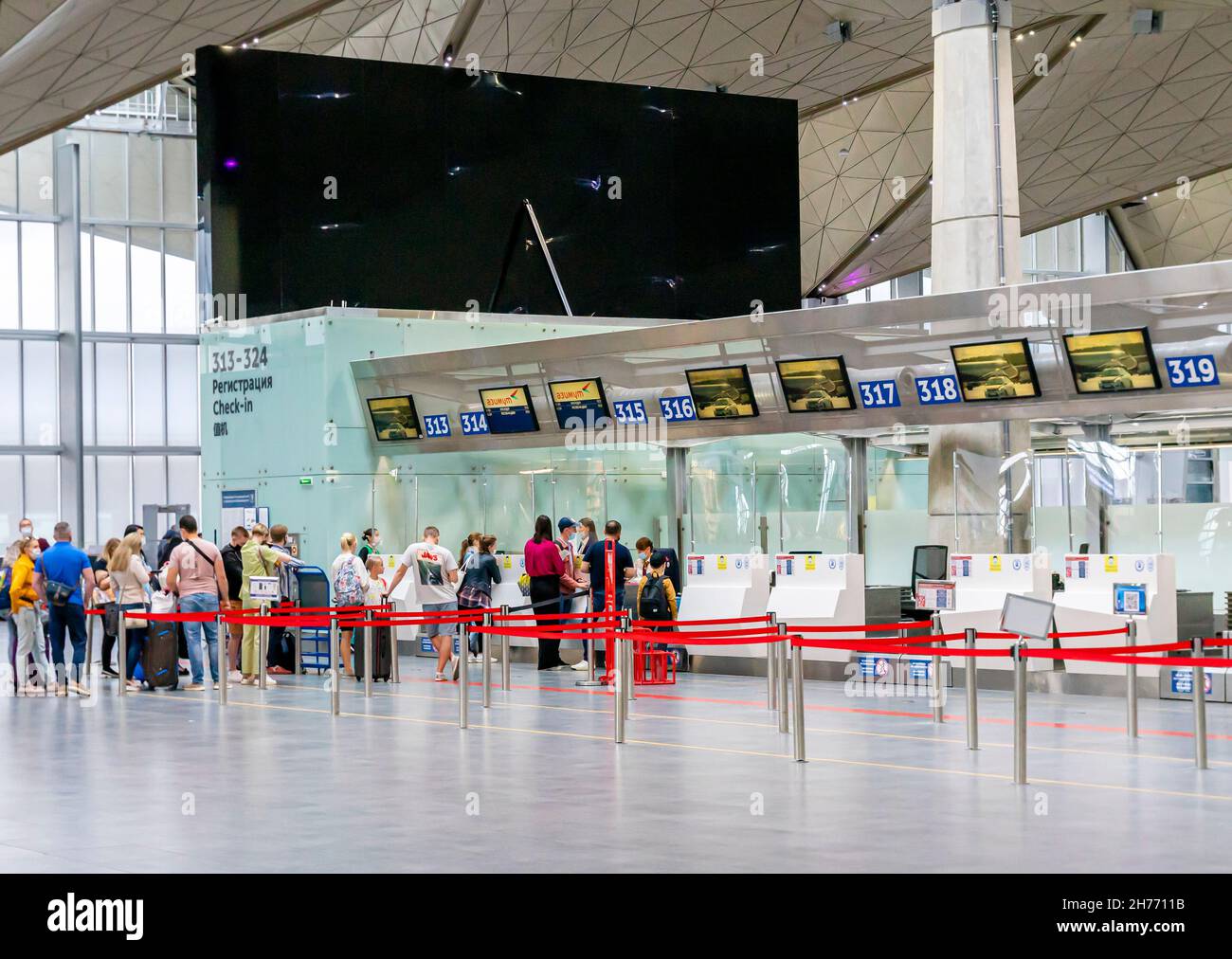 Passengers checking in in half-empty terminal inside Pulkovo international airport, LED, St Petersburg Russia Stock Photo