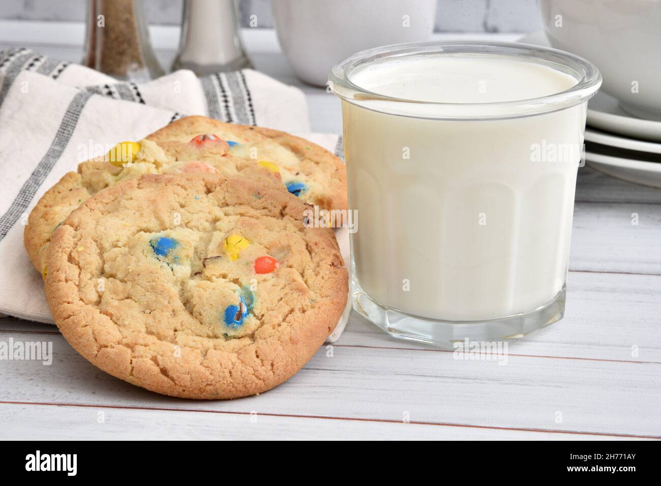 Gourmet homemade sugar cookies with chocolate candy and a glass of milk Stock Photo