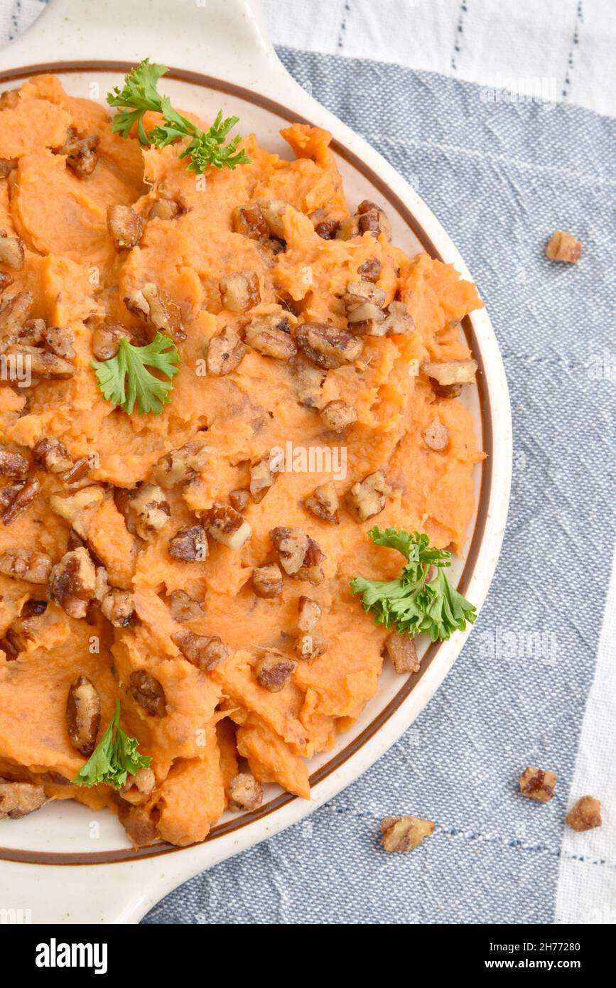 Overhead view of a bowl of fresh homemade sweet potatoes with glazed pecans Stock Photo