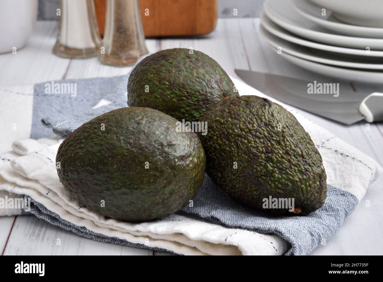Fresh ripe organic avocado on a kitchen towel close up Stock Photo