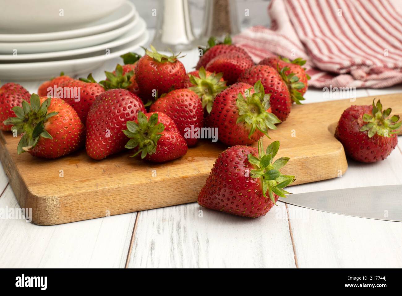 Fresh juicy ripe organic strawberries on a wooden cutting board Stock Photo