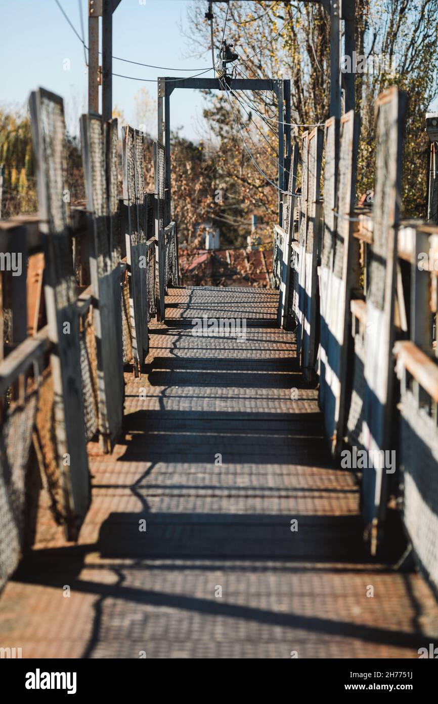 Pedestrian metallic bridge across a railway. Stock Photo