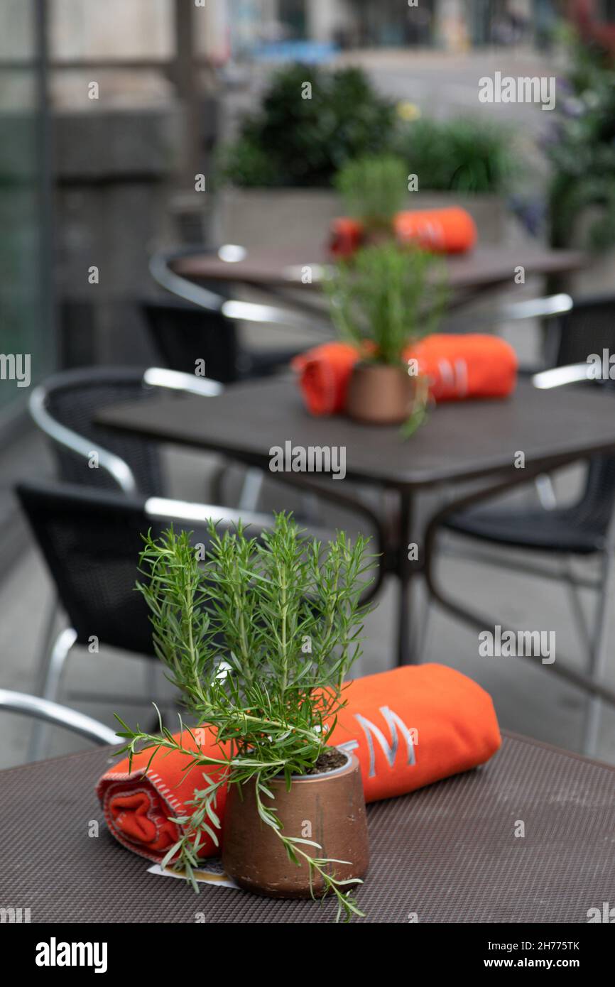 LONDON, UK - JULY 14, 2021:  Outdoor tables at a restaurant with blankets to keep customers warm Stock Photo