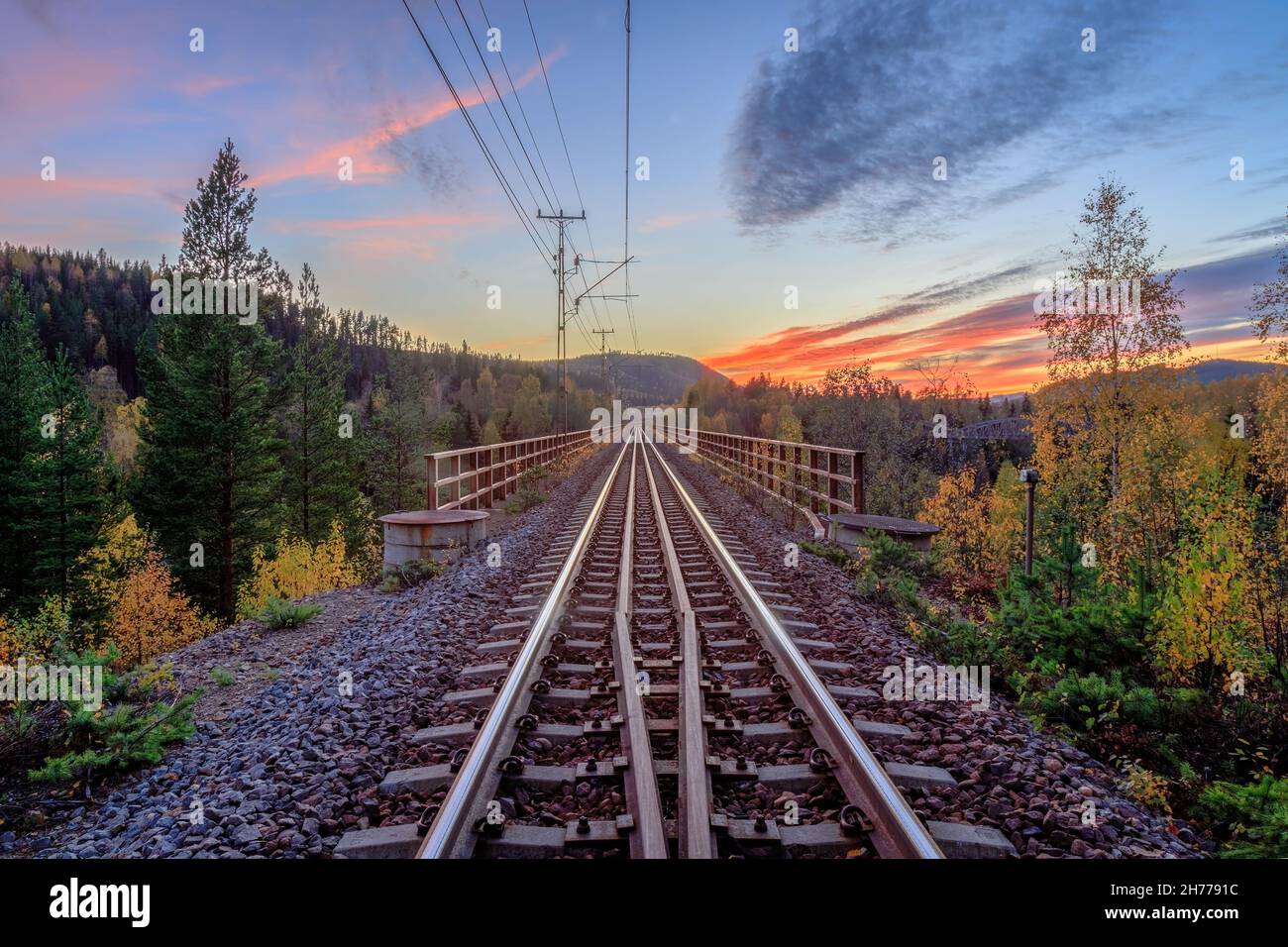 railroad bridge and mountain during sun down Stock Photo