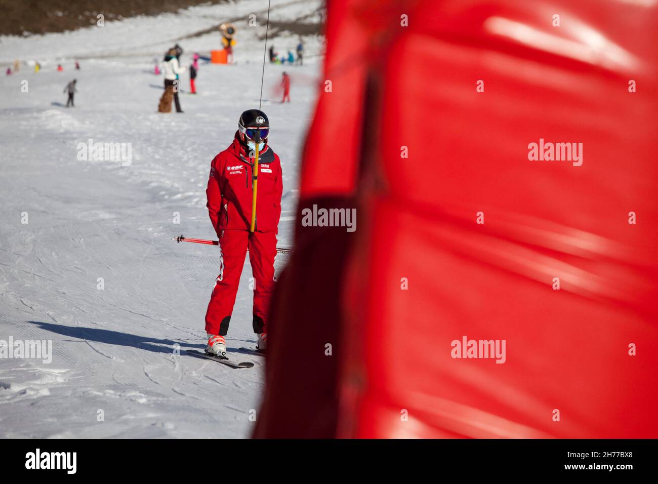 An ESF ski instructor is wearing a surgical mask on a ski lift in ...