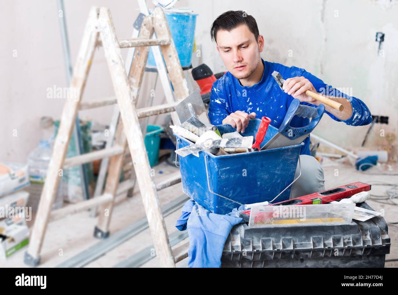 Handyman choosing necessary tool in toolbox Stock Photo