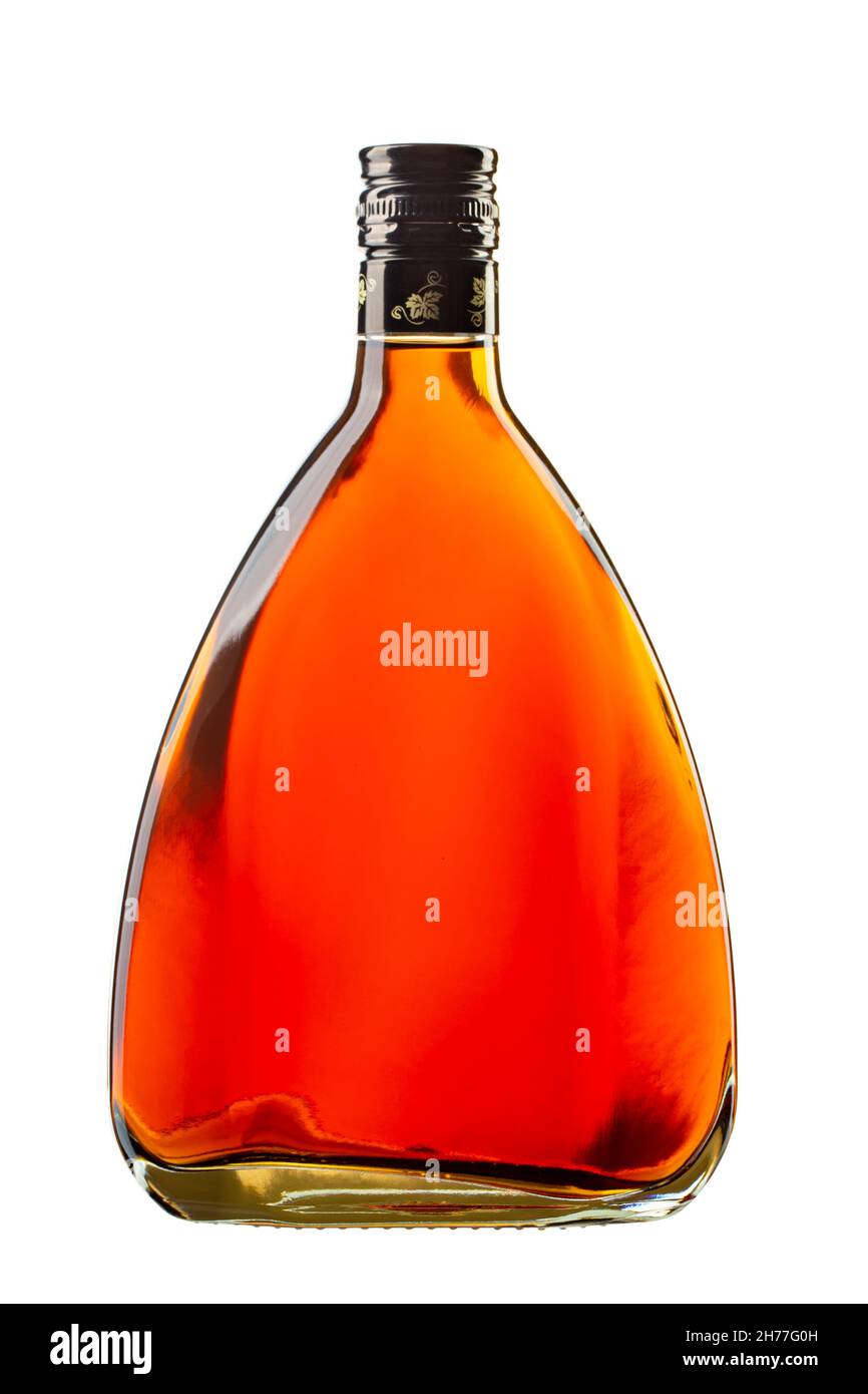 Bottle of amber color premium alcohol, isolated on white background. Ideal for mock-up of whisky, brandy, cognac or rum design. File contains clipping Stock Photo