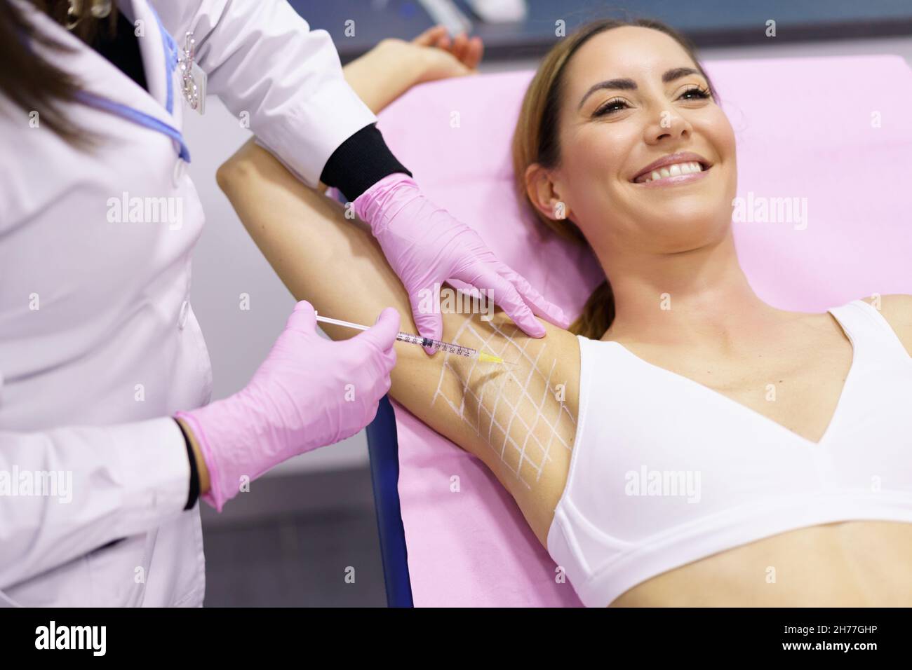 Doctor makes intramuscular injections of botulinum toxin in the