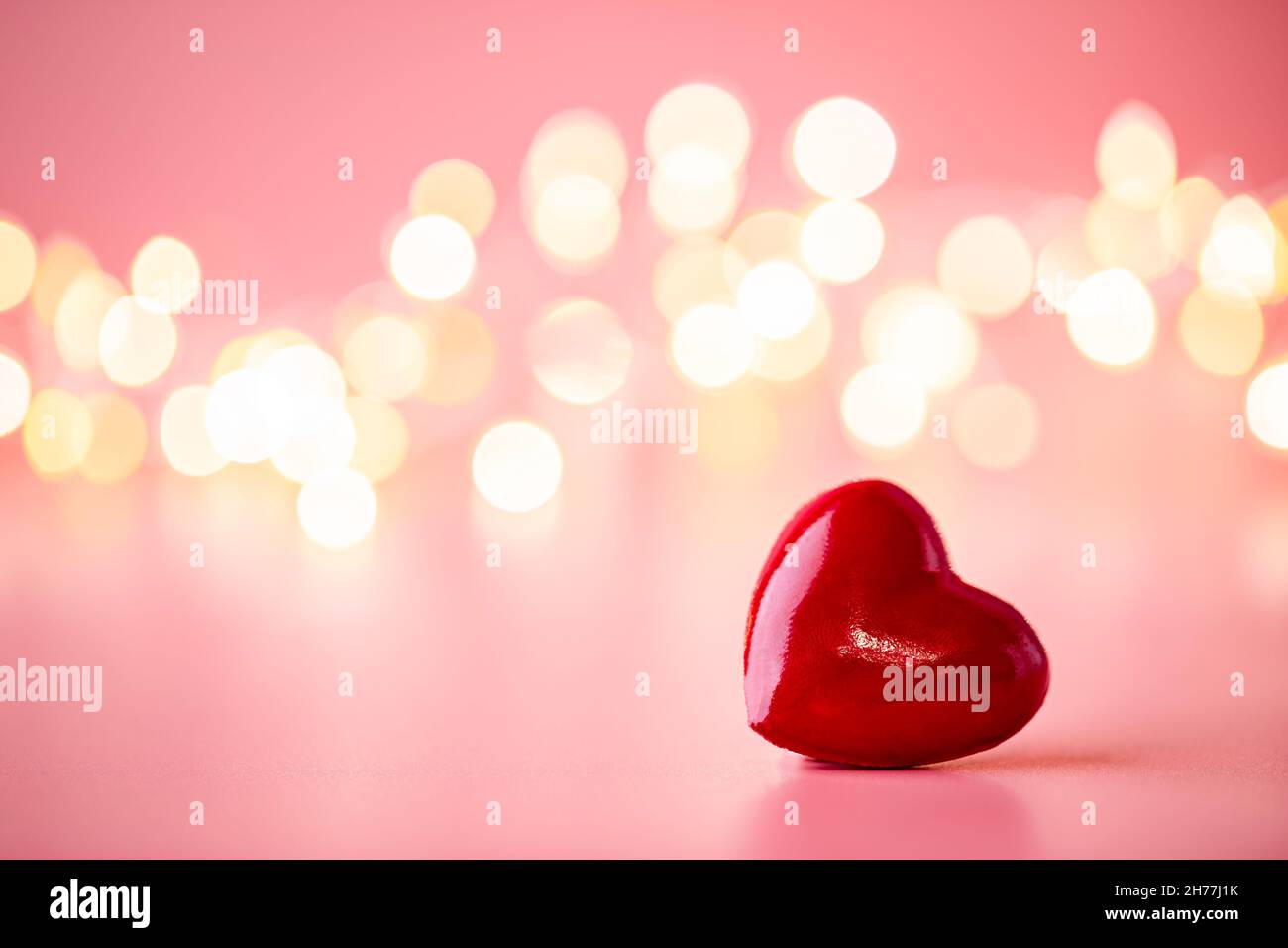 The red Heart shapes on abstract light pink glitter background. Love ...