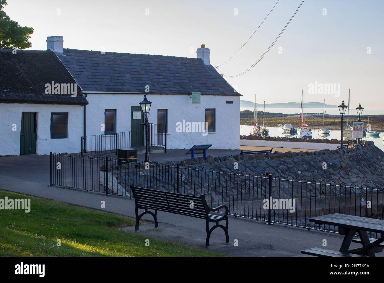 5 July 2018. Groomsport Village harbour in County Down Northern Ireland. The Visitor Centre in the ancient Irish Cottages on Cockle Row  and it's trad Stock Photo